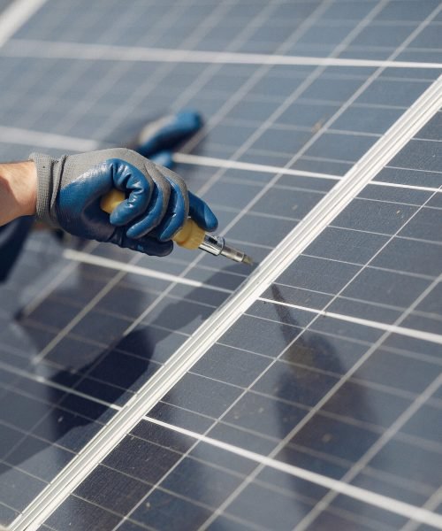 Engineer in a white helmet. Man near solar panel.